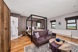 a living room with a bed and a couch at Carnbore House BnB in Bushmills