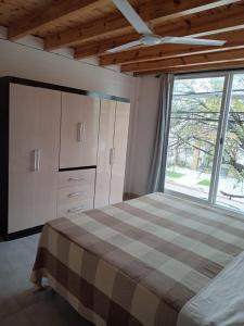 a bedroom with a bed and a large window at DON ESTEBAN - Departamento in Resistencia