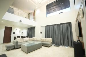 a living room with a couch and a table at 4 BHK Lavish villa in Bhose in Mahabaleshwar