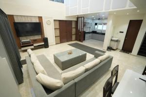a large living room with a couch and a tv at 4 BHK Lavish villa in Bhose in Mahabaleshwar