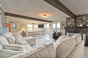 a living room with white couches and a fireplace at Charming Orrs Island Cottage with Ocean Views in Orrs Island