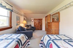 a bedroom with two beds and a living room at Charming Orrs Island Cottage with Ocean Views in Orrs Island