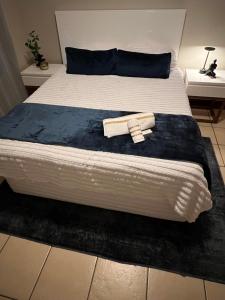 a bed with a blue blanket on top of it at Ruvuka Retreat in Vosburg