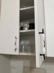 a white kitchen cabinet with a vase on it at Hostel Nelly in Istanbul +35 photos