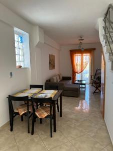 a living room with a table and chairs and a couch at Anestis House in Anaxos