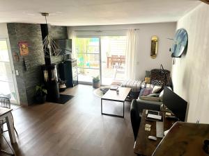 a living room with a couch and a table at Surf, Skate, Golf house Seignosse in Seignosse