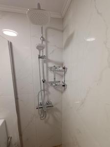 a bathroom with a shower with white marble walls at Holiday Home Klimataria in Áyios Pétros +12 photos