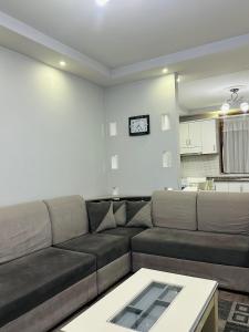 a living room with a couch and a table at Korca Apartment in Korçë
