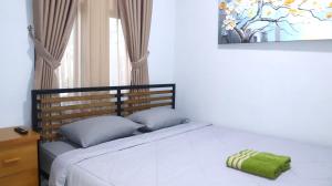 Postel nebo postele na pokoji v ubytování Cataleya Homestay Lagoi Bintan