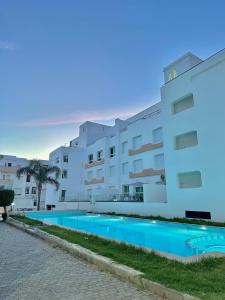 a building with a swimming pool in front of it at Achakar Hill in Tangier