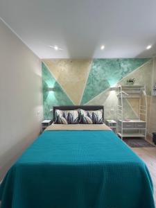 a bedroom with a bed with a green blanket at Corte Verde 5 in Bari