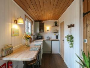 a kitchen with a wooden ceiling and a wooden counter at The Heron in Cambridge