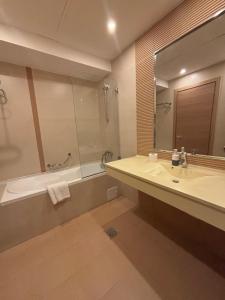a bathroom with a sink and a tub and a mirror at CAMA Vip Room's in Bucharest