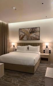 Postel nebo postele na pokoji v ubytování الإقامة الذهبية للشقق المخدومة Golden Residence Hotel