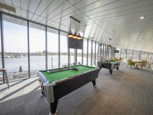 a billiard room with a pool table and windows at Starlight Skylight - Billing Aquadrome in Northampton