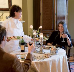 a group of people sitting around a table with wine glasses at Hotel Soraya in San Benedetto del Tronto