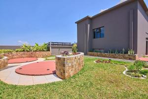 a house with a brick wall and a patio at Leshwa House 1 in Nairobi