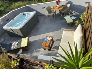 a hot tub on a patio with a table and chairs at Dalmatia Nin Apartment with Private Jacuzzi in Nin