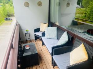 a balcony with two chairs and a table at Apartment Bergliebe Bad Goisern in Bad Goisern +3 photos