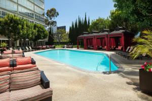 a swimming pool with lounge chairs next to a building at Sheraton Gateway Los Angeles Hotel in Los Angeles