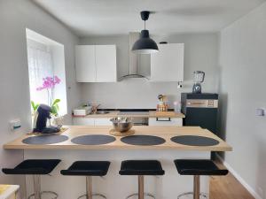 a kitchen with a island with bar stools at Lila Natur León1 Apartment 4 Pers in Villafañé
