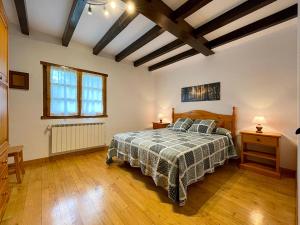 a bedroom with a bed and a wooden floor at Larrapil in Etxalar