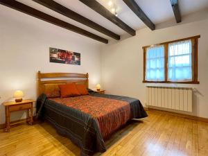 a bedroom with a large bed and a wooden floor at Larrapil in Etxalar +11 photos