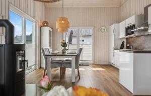 a kitchen with a table and chairs in a room at Awesome Home In Ostseeresort Olpenitz in Olpenitz