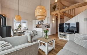 a living room with two couches and a tv at Awesome Home In Ostseeresort Olpenitz in Olpenitz