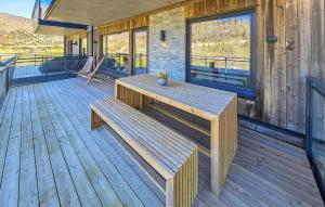 a wooden deck with a bench on a house at Stunning Apartment In Hemsedal in Hemsedal