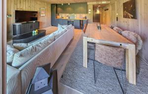 a living room with a large couch and a table at Stunning Apartment In Hemsedal in Hemsedal