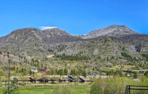 a mountain with a village and houses in front of it at Stunning Apartment In Hemsedal in Hemsedal +15 photos