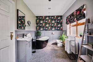 a bathroom with a bath tub and a sink at Carnbore House BnB in Bushmills +37 photos