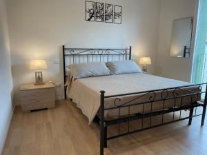 a bedroom with a bed and a nightstand with two lamps at Casa Tina in Ravenna