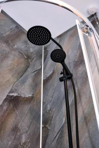 a shower head in front of a marble floor at Carnbore House BnB in Bushmills