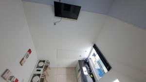 an overhead view of a bathroom with a tv on the wall at Pousada do sol in Sorocaba