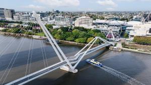a bridge over a river with a boat on it at InterContinental Brisbane by IHG in Brisbane +52 photos