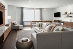 a living room with a couch and a table at Element Calgary Downtown in Calgary