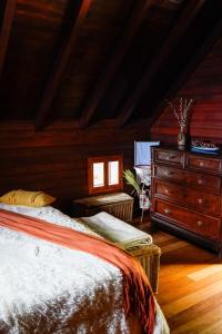 a bedroom with a bed and a dresser and a window at Refúgio do Norte in Porto Moniz +18 photos
