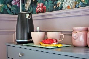 a table with two cups and a kettle on it at Carnbore House BnB in Bushmills
