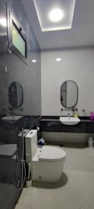 a bathroom with a toilet and a sink at Villa 6 in Ajman 