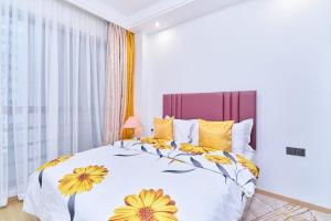 a bedroom with a bed with yellow flowers on it at Leshwa House 1 in Nairobi +59 photos