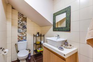 a bathroom with a toilet sink and a mirror at Villa Thimari by Villa Plus in Melidhónion +21 photos