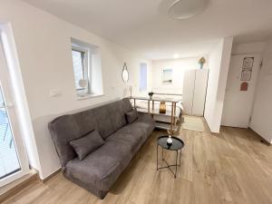 a living room with a couch and a table at Casa Orange in Koper