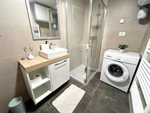 a bathroom with a washing machine and a washer at Casa Orange in Koper