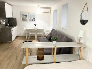 a living room with a couch and a table at Casa Orange in Koper