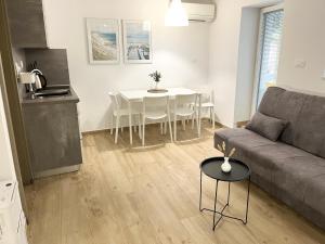 a living room with a couch and a table at Casa Orange in Koper