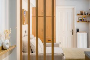 a bedroom with a bed with wooden dividers at Atherial Studio in Athens +8 photos