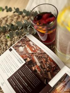a magazine sitting on a table with a book and a drink at Kairos Apartments - Family - darmowy Parking, blisko centrum in Gliwice +29 photos