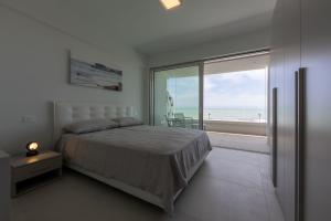 a bedroom with a bed and a view of the ocean at Residenze Da Vinci Azzurro in Senigallia +36 photos